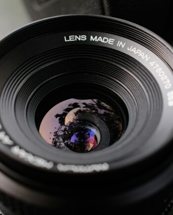 Detailed image of a vintage camera lens showcasing precise reflections and craftsmanship.